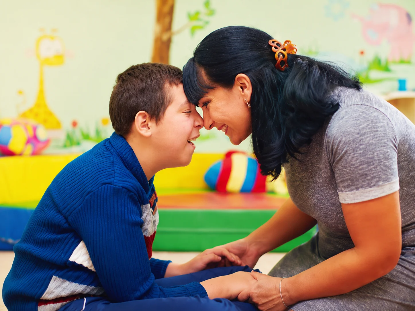 Support worker helping a young person with an everyday learning activity
