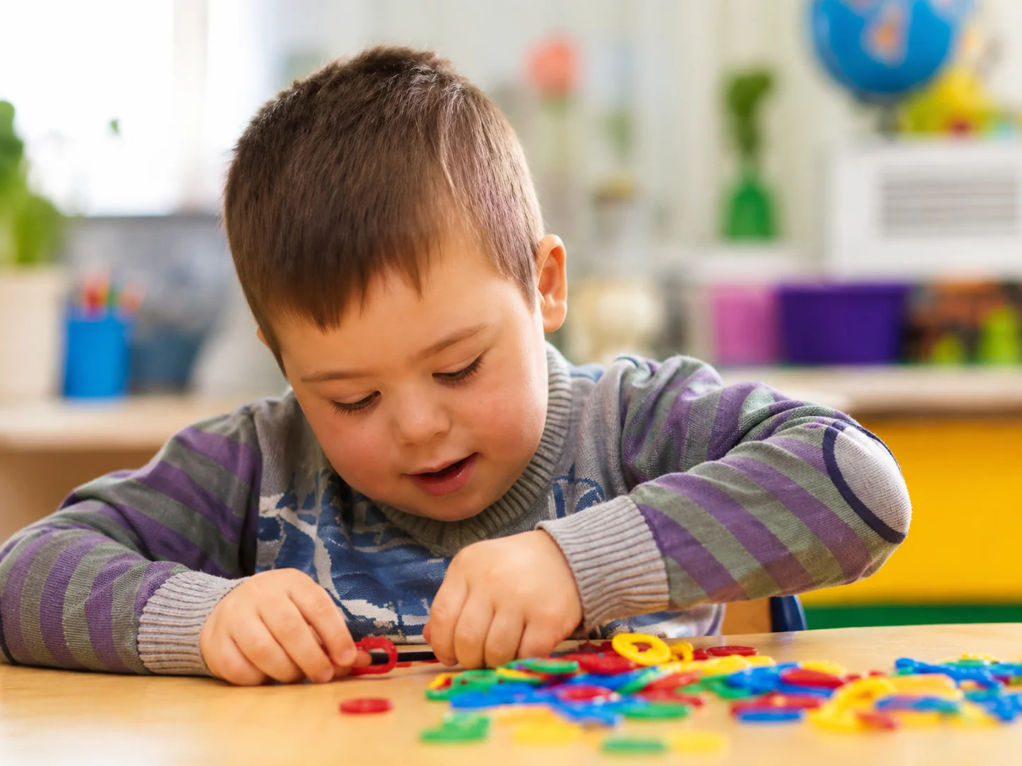 Child receiving calm, supportive care in a bright play setting